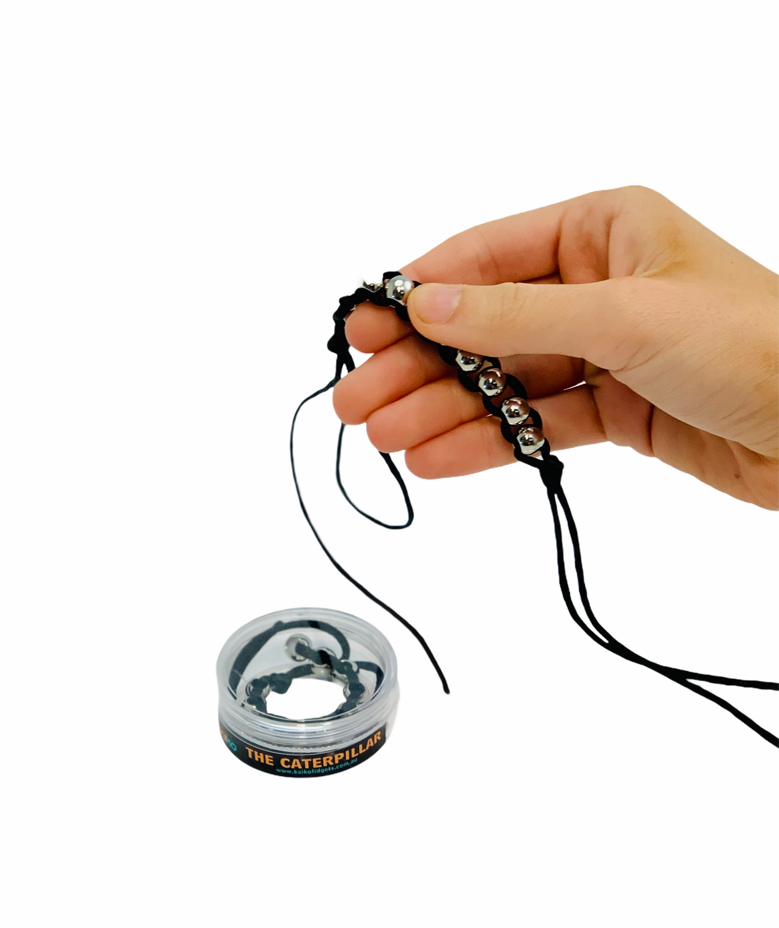 Kaiko Caterpillar Fidget with hand holding the fidget above storage box on white background