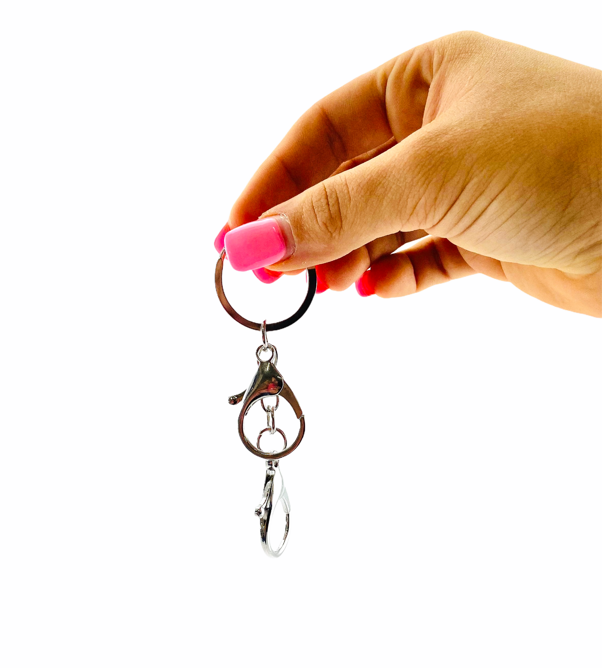 Hand holding up the Kaiko Fidget Keyring on white background