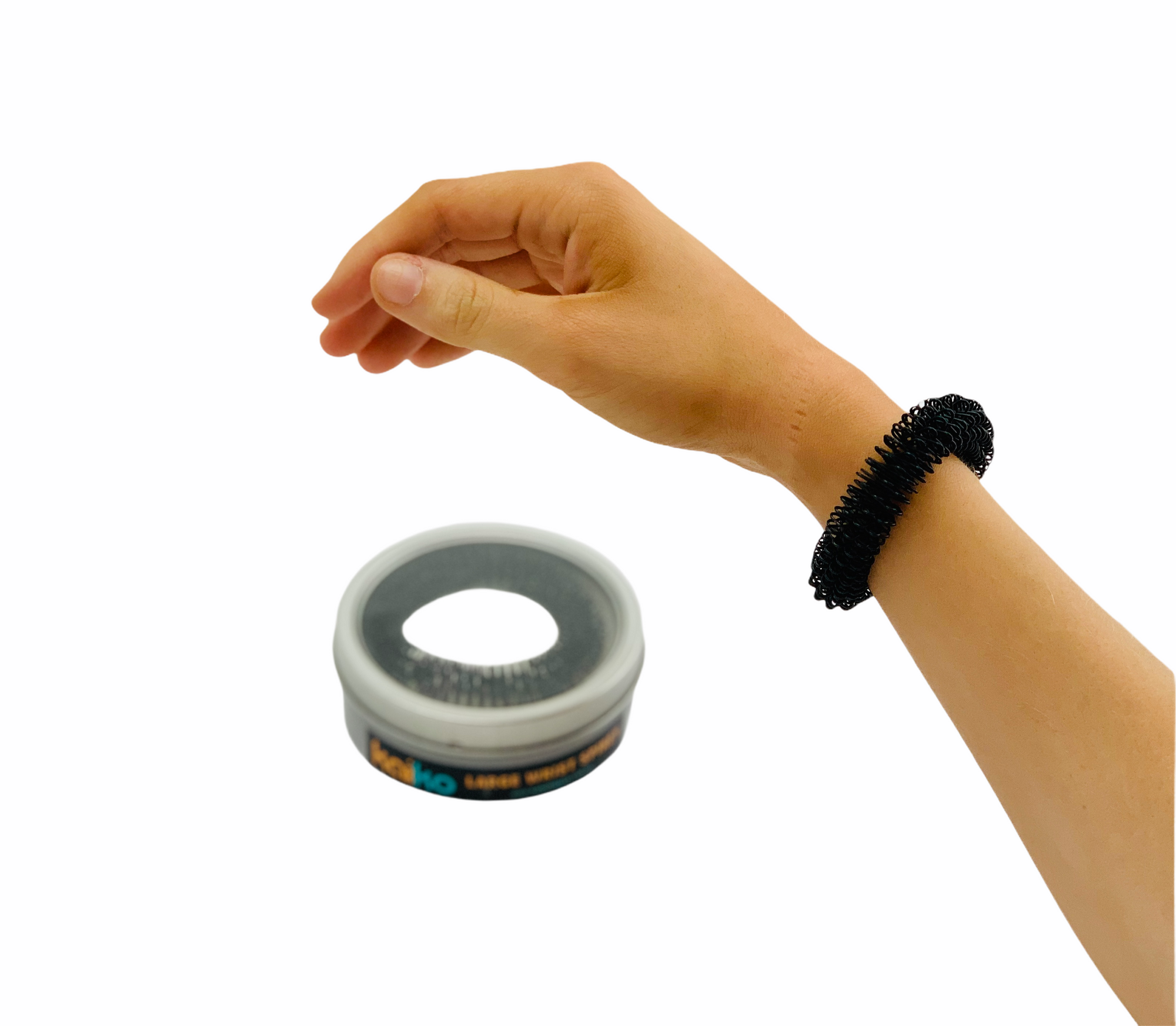 Hand wearing Kaiko Spiky Fidget - Large in black in front of storage box on white background