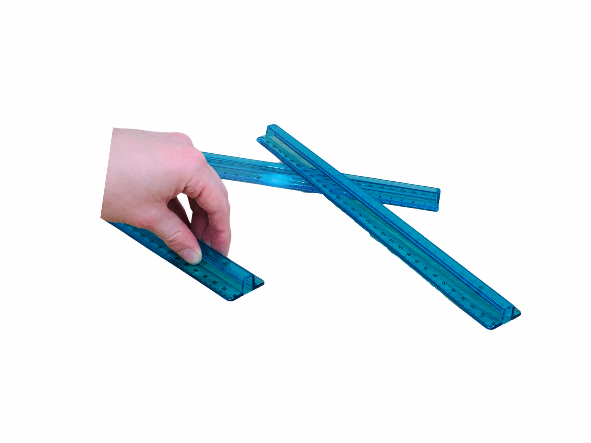 a hand holding a Micador Review Ruler next to 2 on top of each other