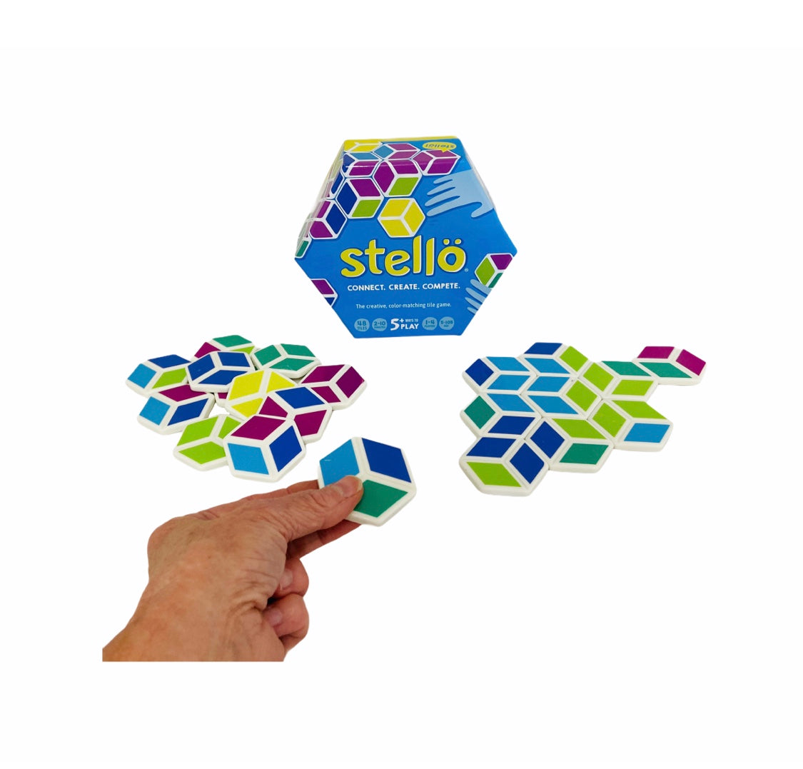 a hand holdig a piece from the Mobi Stello Colour Matching Game in front of box