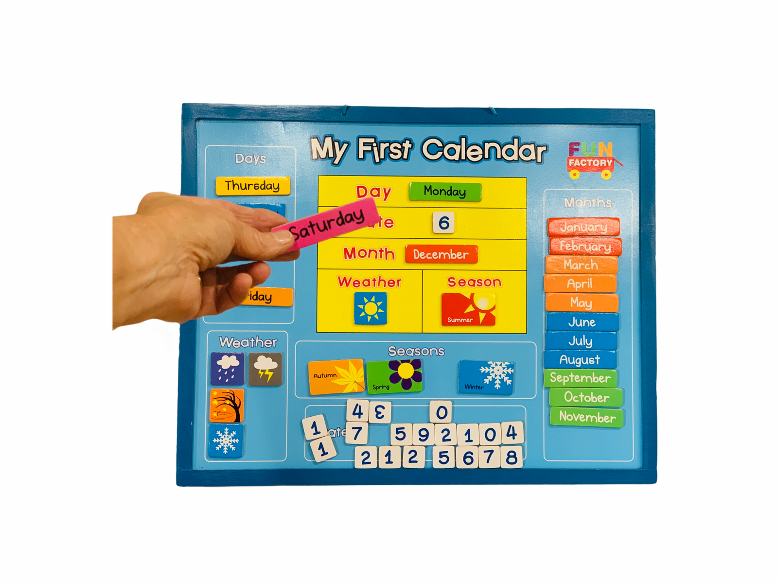 a person sticking the Saturday piece on the My First Calendar