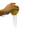 a hand holding the yellow Plui Rain Ball with water draining out l