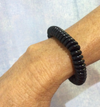 Wrist wearing the Chubuddy Springz Bracelet - Black with a white background