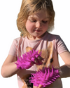 a young girl wearing the spiky sensory gloves