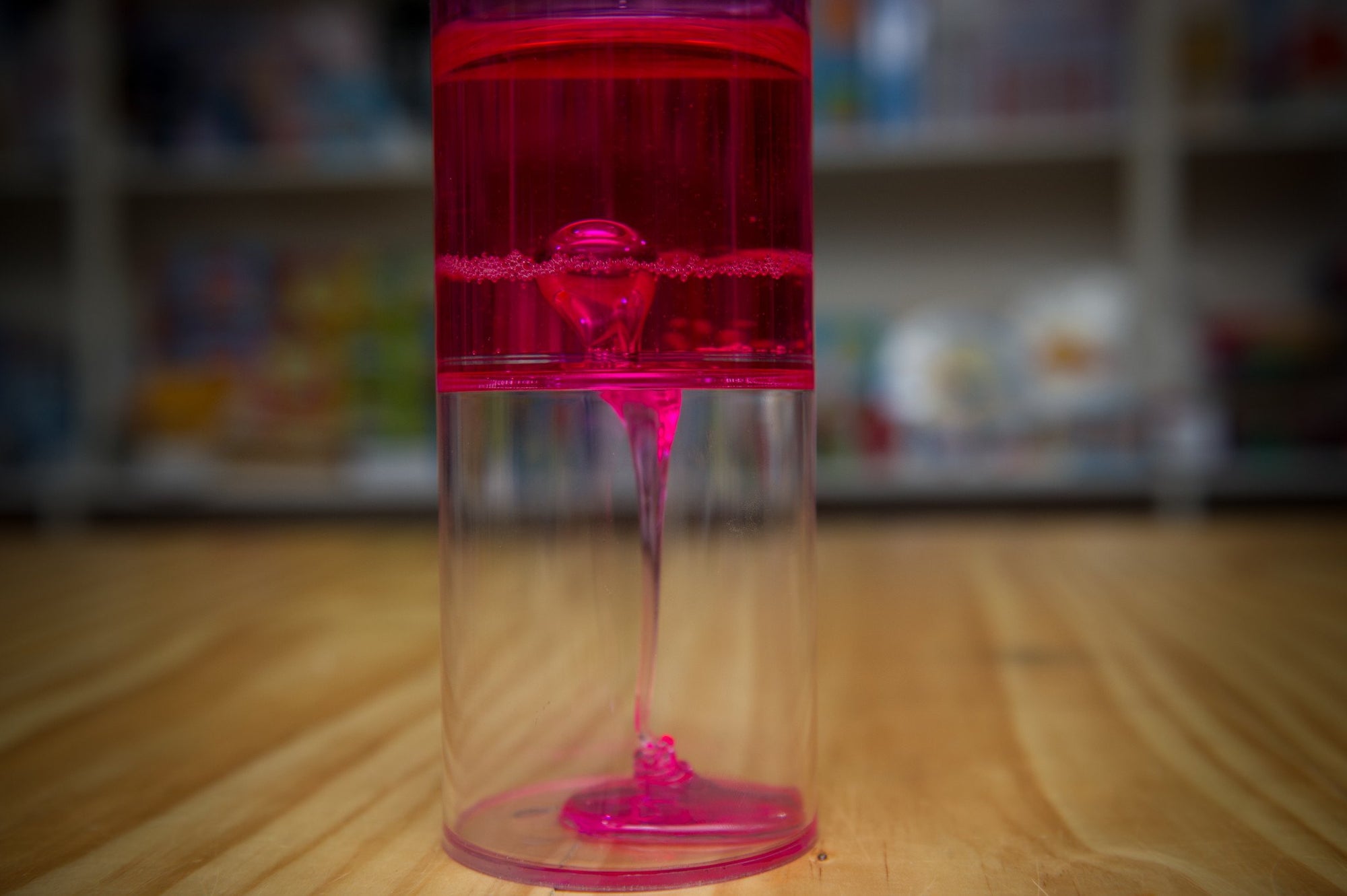 the red sensory sensations Ooze Tube on wooden table