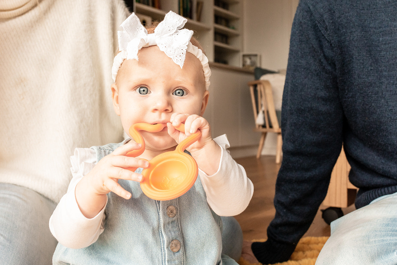 a baby chewing on the orange Fat Brain Lil&#39; Dimpl