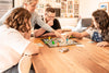 a group of people playing the Peaceable Kingdom Space Escape board game