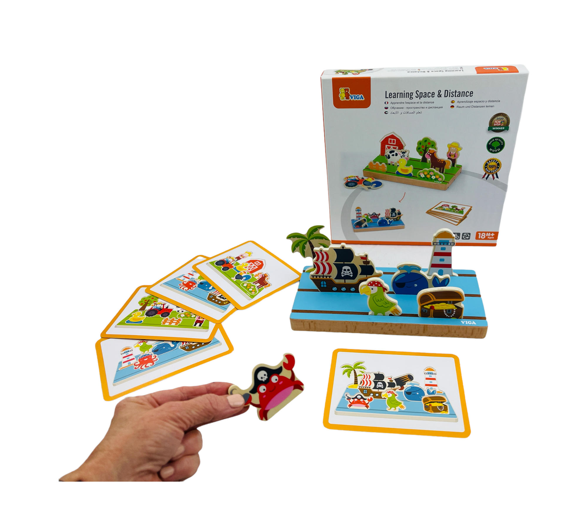 VIGA Learning Space and Distance on display with pieces in front of the box and a hand holding up the crab 