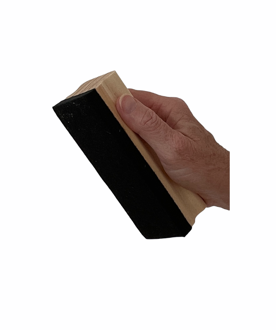 Hand holding Wooden Duster on a white background